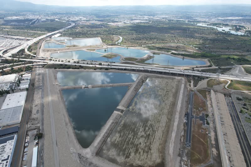 Wide aerial photo of spreading basins and the surrounding valley